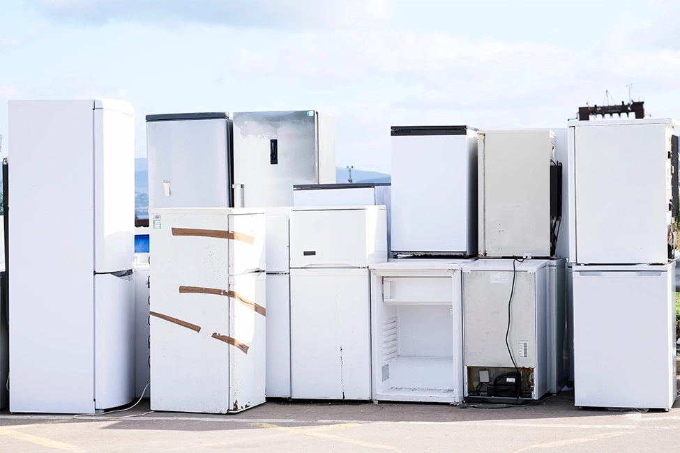Fridge freezer disposal taking place at a scrap yard